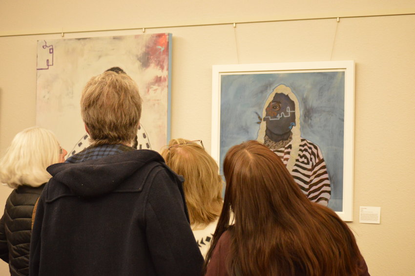 People looking at Danielle SeeWalker's artwork on Nov. 10 at Koelbel Library.
